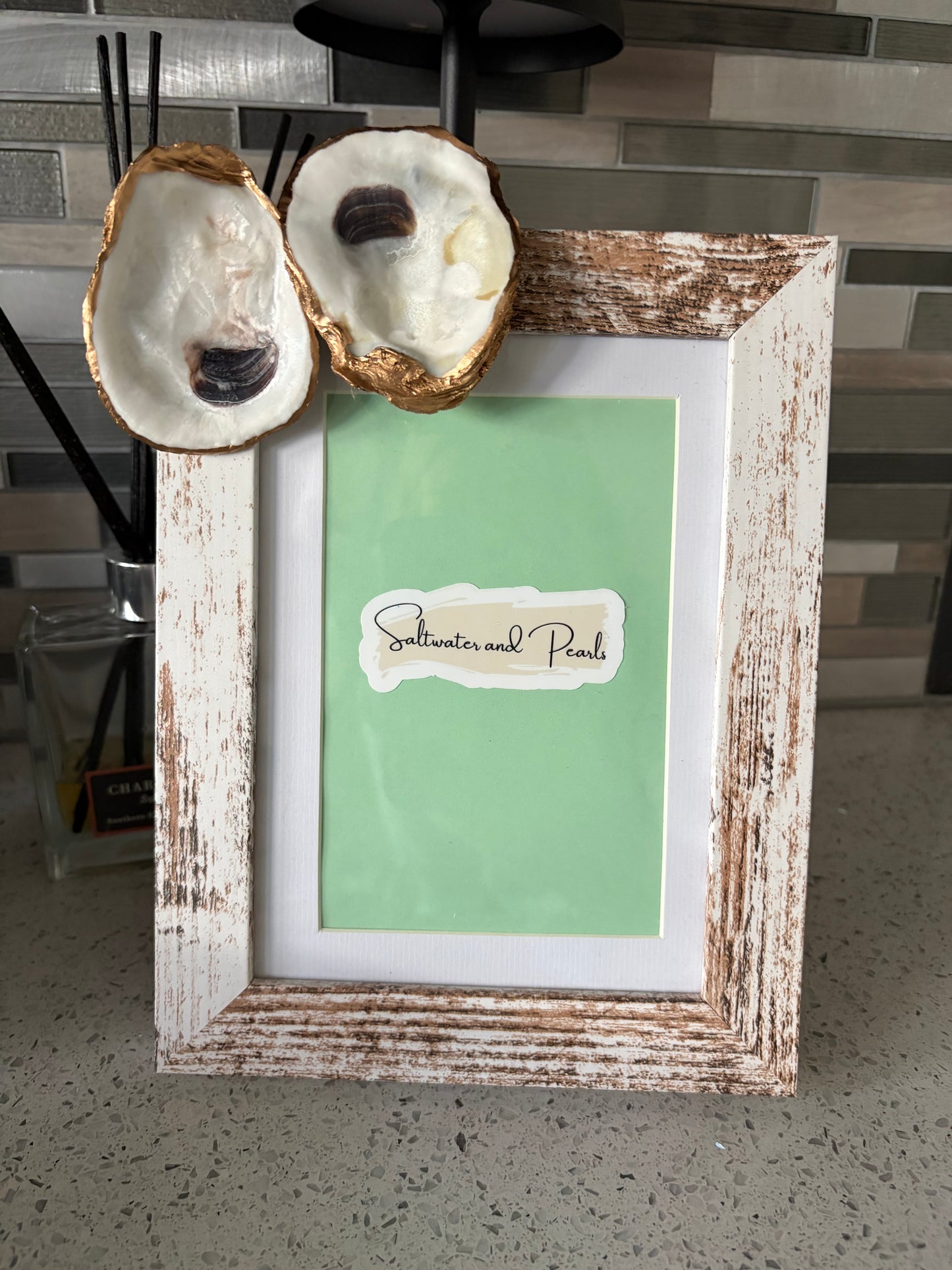White distressed picture frame featuring 2 natural oyster shells