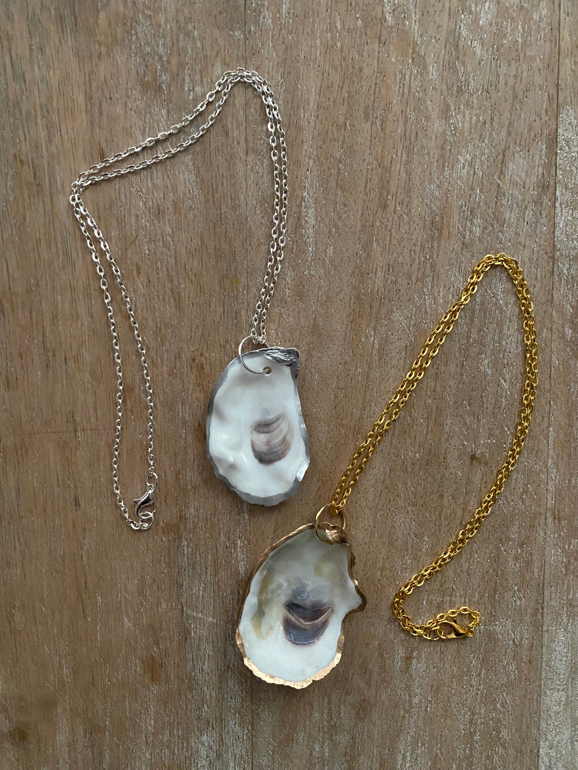 Single oyster shell pendant on gold or silver chain.