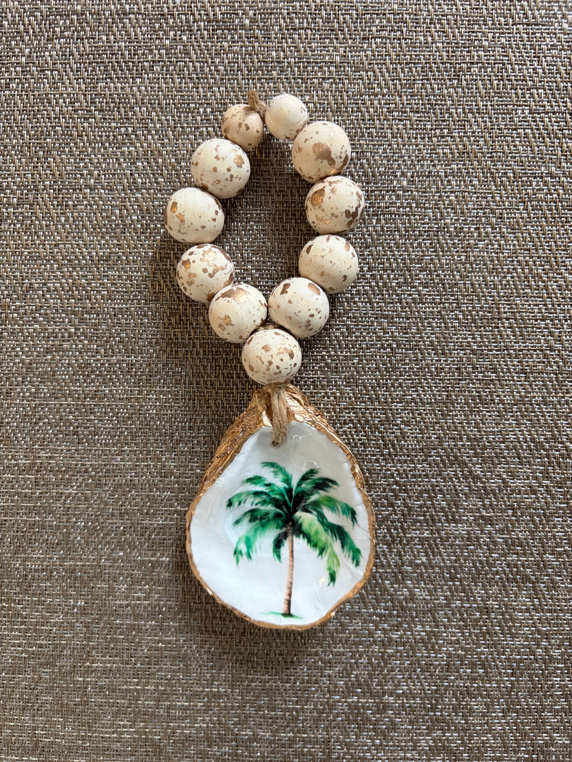 Napkin ring or wine bottle charm featuring a palm tree. 